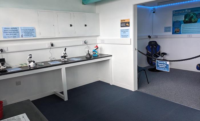 A modern room with microscopes, VR headsets and childrens activities